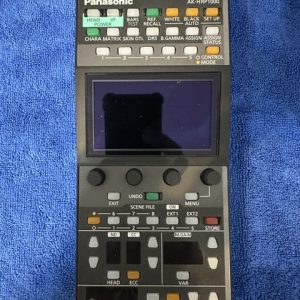 Panasonic AK-HRP1000 camera remote control panel with display screen and many labeled buttons on a blue towel.